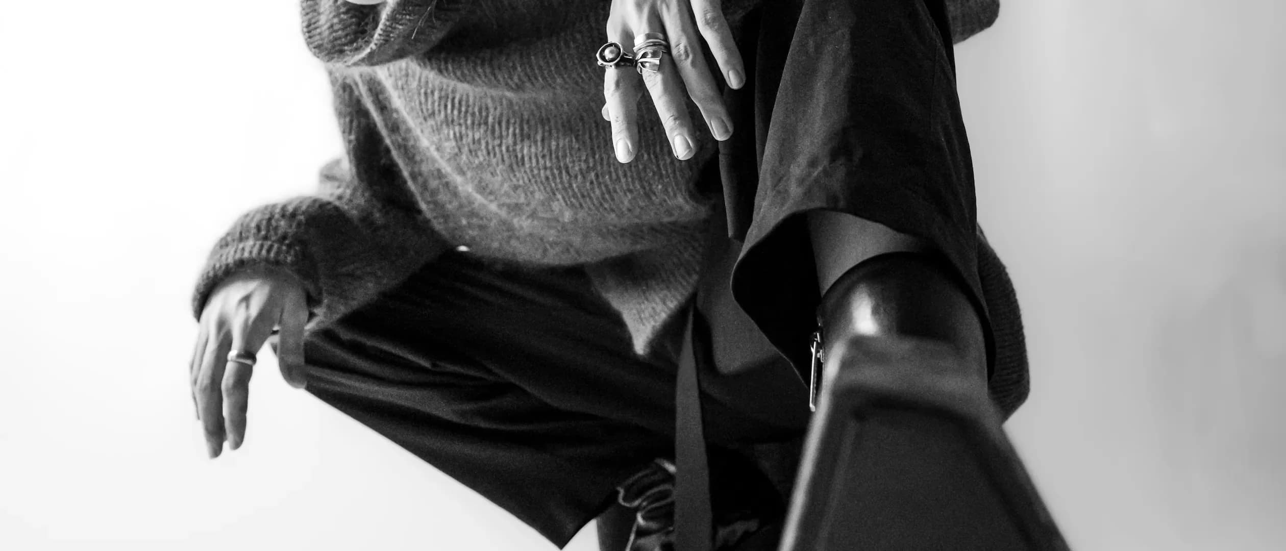 a woman is sitting on a chair with her hand on her hip