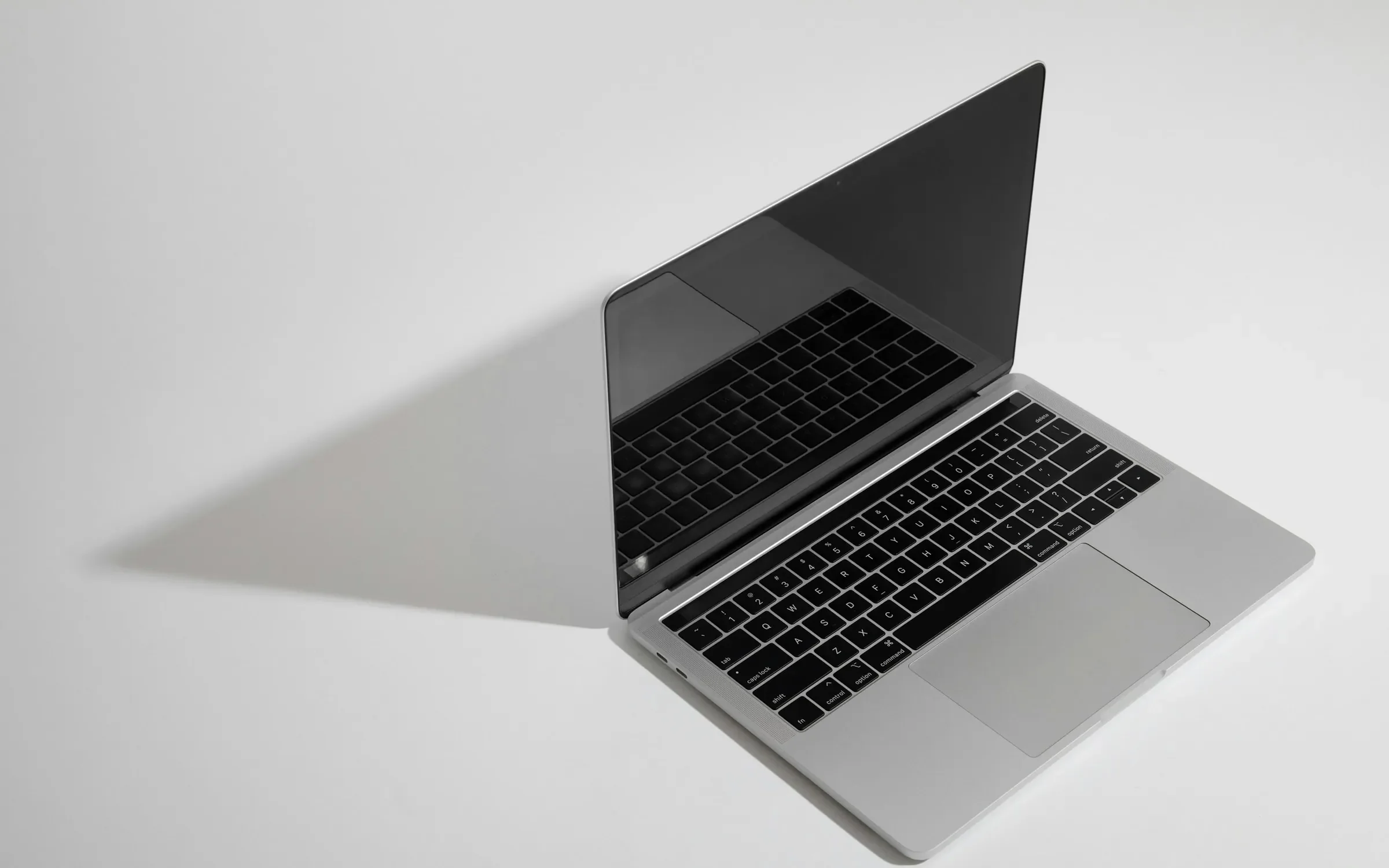 macbook pro on white table